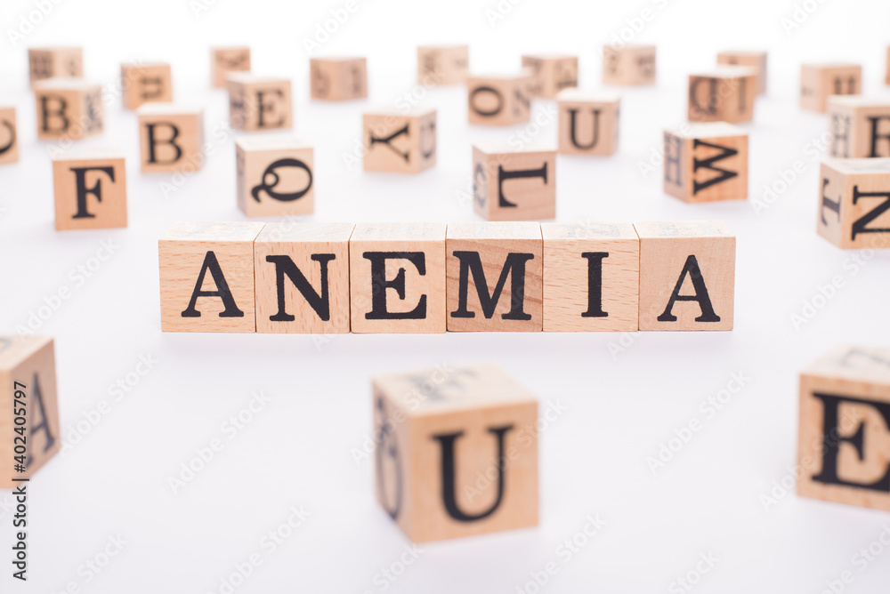 Anemia concept. Close up view photo of wooden cubes making showing word anemia on white table