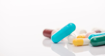 Cropped close up view photo of pile heap of multicolored pills isolated white backdrop table desk with copy space