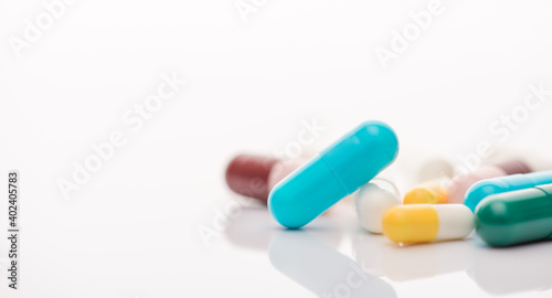 Cropped close up view photo of pile heap of multicolored pills isolated white backdrop table desk with copy space