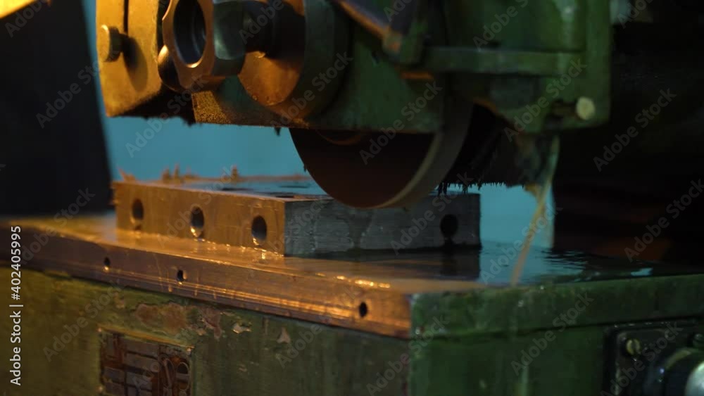 Close-up of a grinding machine working in a factory with sparks. Close-up of a grinding machine working in a factory with sparks.