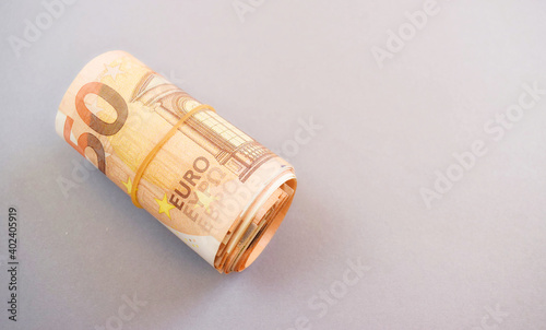 Close-up Rolled Euro Banknotes, copy space.Gray background.