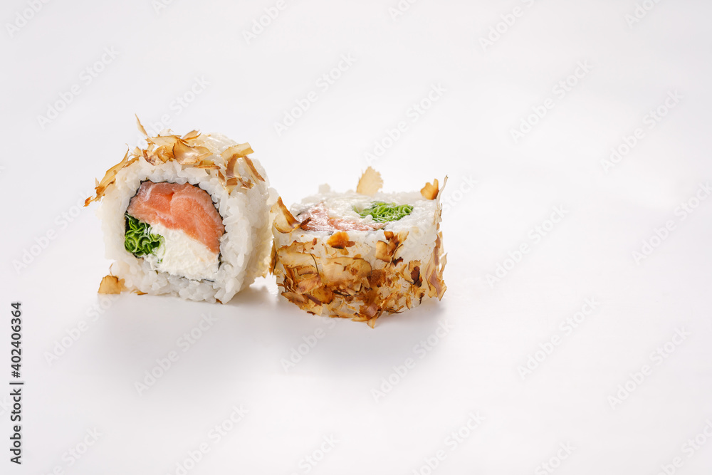 Sushi rolls with tuna shavings on a white plate. Isolated. Restaurant concept. Close-up. Sushi rolls with tuna shavings on a white plate. Isolated. Restaurant concept. Close-up.