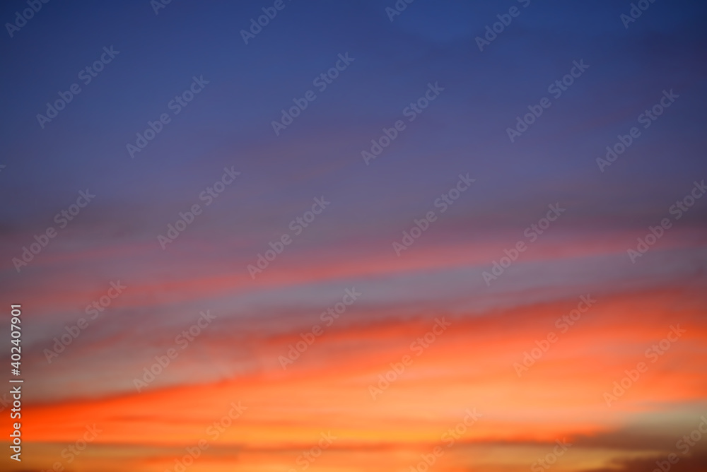 Beautiful view of sunset and orange sky at twilight time above the clouds with dramatic light.
