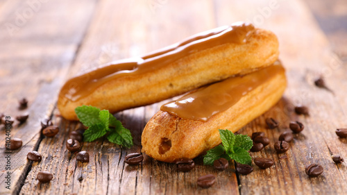 Fototapeta Naklejka Na Ścianę i Meble -  coffee eclair on wood background