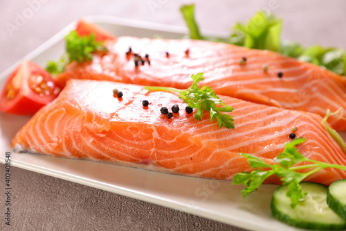 raw salmon fillet and herbs