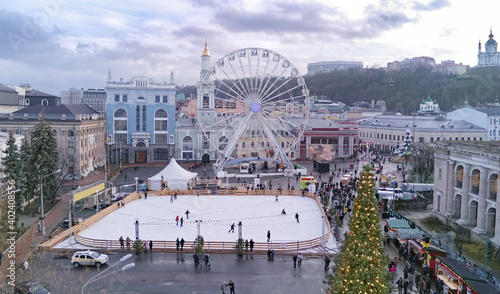 Aerial view of Christmas market Kyiv, Ukraine. Ferris wheel, ice rink, Christmas tree and decoration at Kontraktova square on Podil 