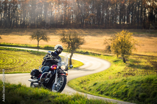 Obraz na plátně classic motorbike rider riding in autumn nature