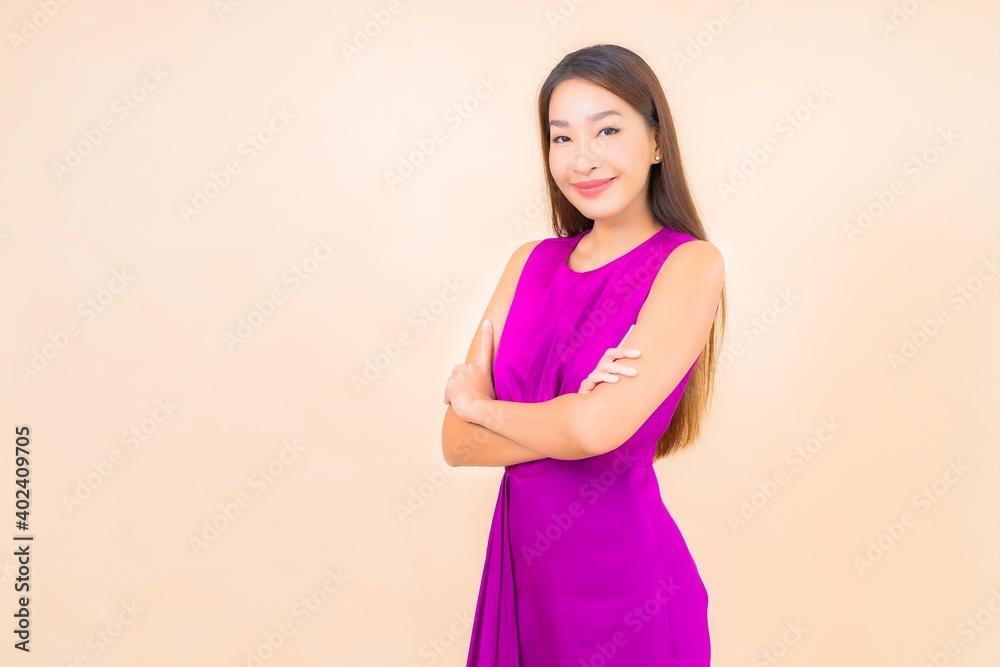 Portrait beautiful young asian woman in action on color background