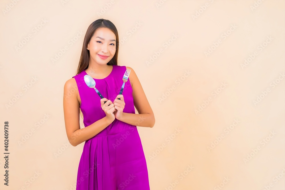 Portrait beautiful young asian woman with fork and spoon