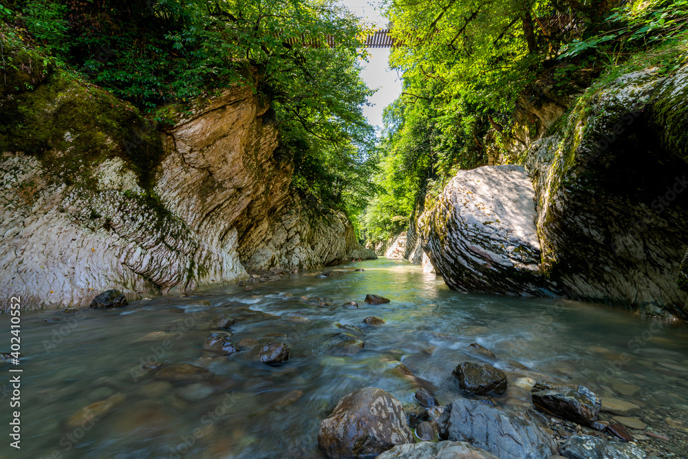 Fototapeta premium Small quiet river in a mountain canyon