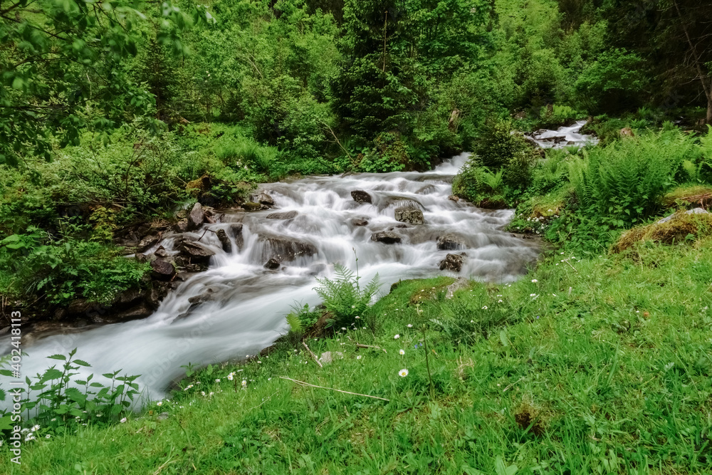 fast flowing torrent with many steps in the mountains while hiking fast flowing torrent with many steps in the mountains while hiking