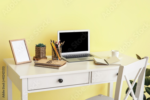 Modern workplace with laptop and decor