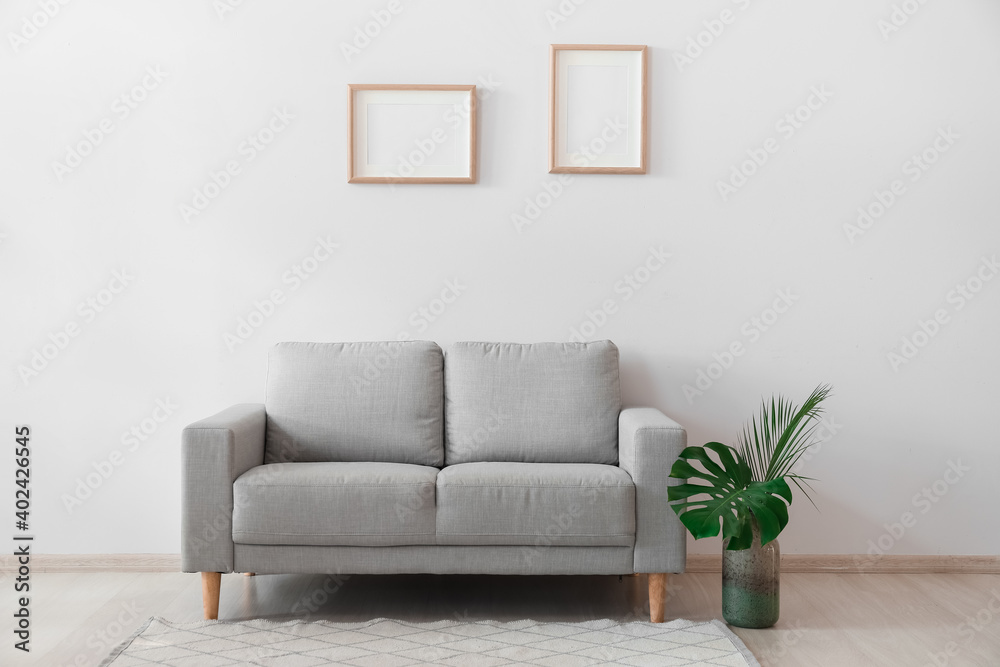Fototapeta premium Stylish sofa in interior of living room