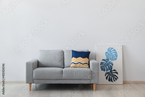 Stylish cozy sofa near ligh...
