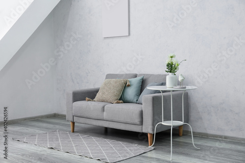 Stylish sofa in interior of...
