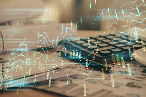 Double exposure of financial chart drawings and desk with open notebook background. Concept of forex market