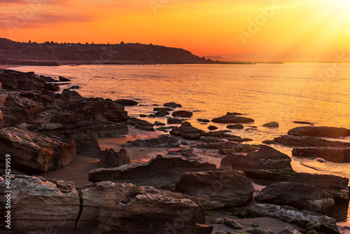 Colorful sunrise on the rocky sea coast