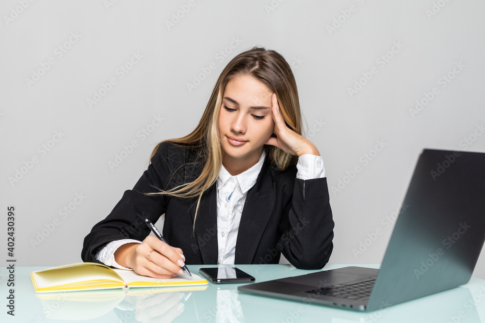 Young businesswoman working with documents in office, sitting at work table with laptop, serious employee checking financial report, project statistics, reading correspondence Young businesswoman working with documents in office, sitting at work table with laptop, serious employee checking financial report, project statistics, reading correspondence