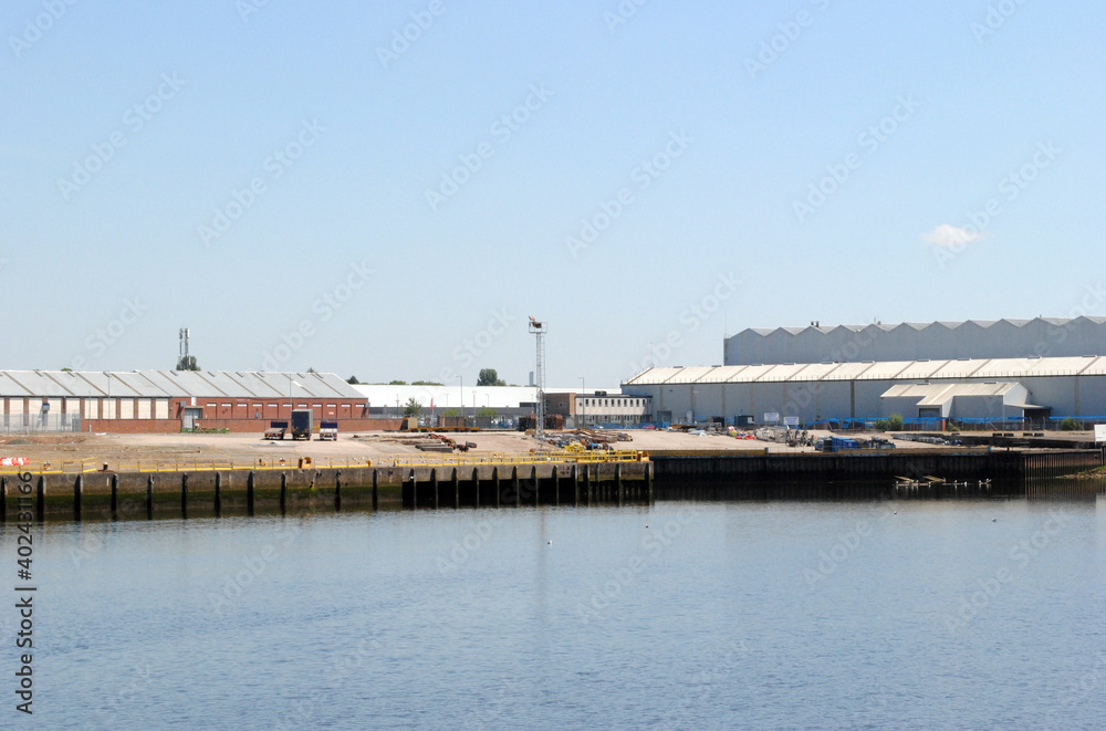 Industrial Buildings Beside Wide Calm River on Sunny Day with Blue Sky 10916-8343-038
