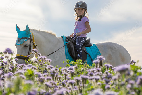 young girl on a white horse 