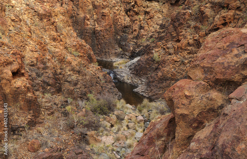 Gran Canaria, landscapes along the hiking route around the ravive Barranco del Toro at the southern part of the island, full of caves and grottoes, close to San Agustin resort, water is running in th