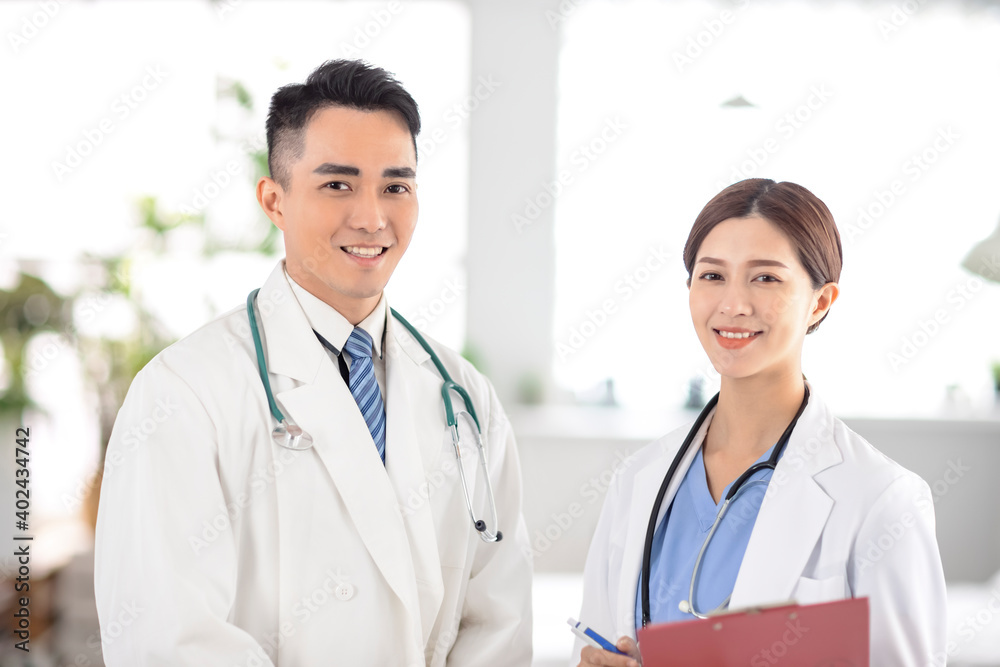 two doctors smiling and standing in Hospital two doctors smiling and standing in Hospital