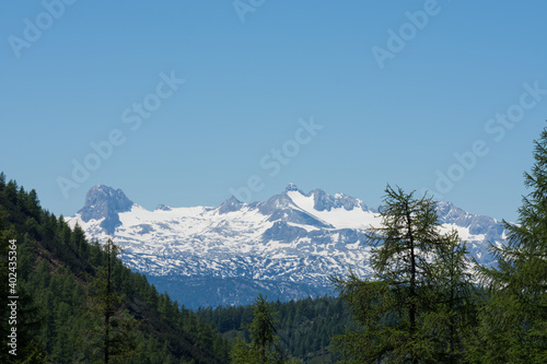 mountains with many peaks and snow with blue sky