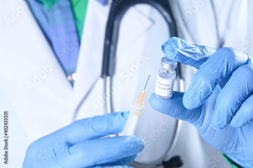 doctor hand in gloves holding coronavirus vaccine  close up