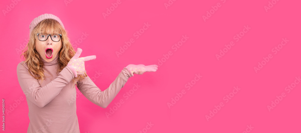 isolated adult woman pointing surprised wearing warm clothes