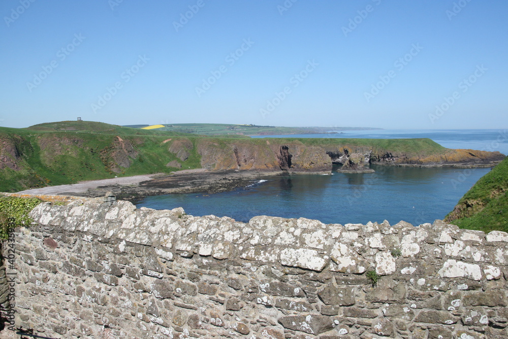 Beautiful green coastline with old structures on the scottish coastline Beautiful green coastline with old structures on the scottish coastline