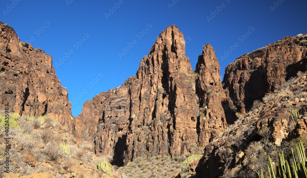 Fototapeta premium Gran Canaria, landscapes along the hiking route around the ravive Barranco Hondo, The Deep Ravine at the southern part of the island, full of caves and grottoes, close to small village Juan Grande