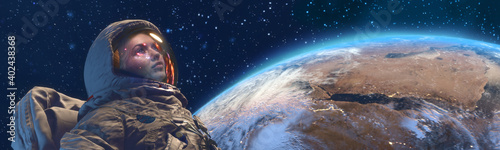 A female astrounaut in outer space against the Earth planet on background