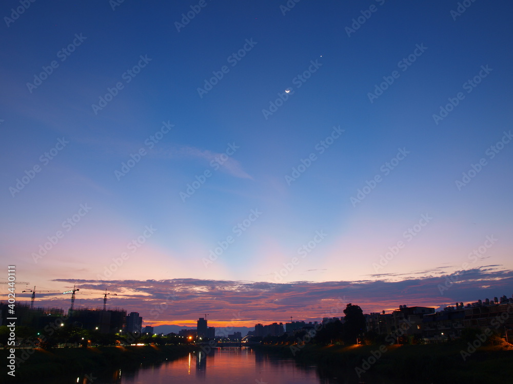 moon accompanied by a star over the cityscape at dawn moon accompanied by a star over the cityscape at dawn