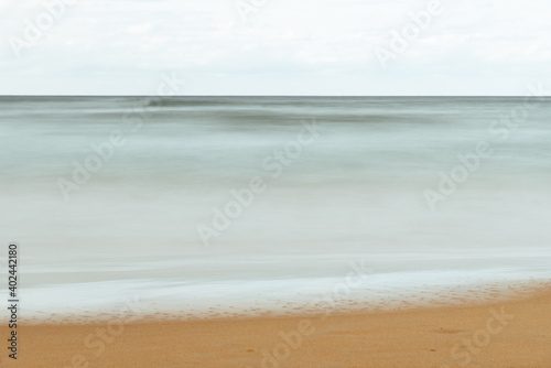 Long exposure view of sandy beach. Blurred background. Natural background with space for copy. Horizontal