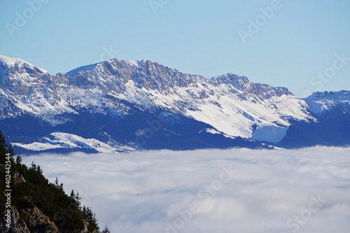 Mountain peaks in the winter, with sea of white clouds - Carpathian Mountains, Romania