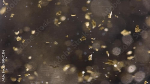 Gold leaf floating in gin Christmas liquor drink macro detail (ID: 402442596)