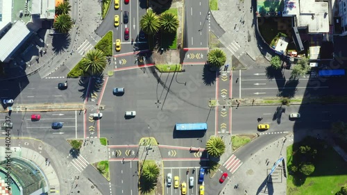 Aerial top down still video of a large crossing with many cars and people in a busy street in the business district of Quito; the capital of Ecuador; South America