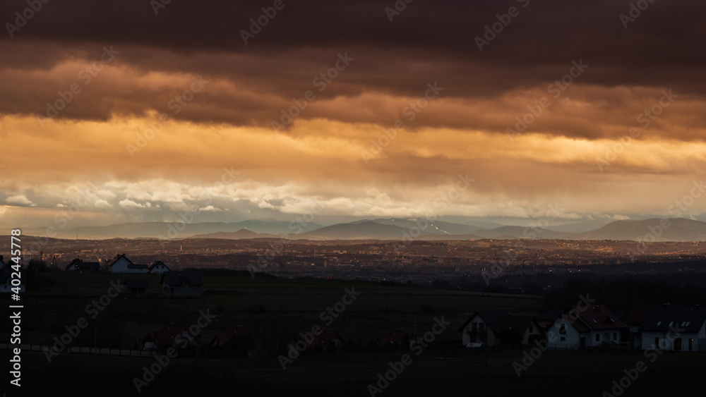 Fototapeta premium dramatic clouds during sunrise over city