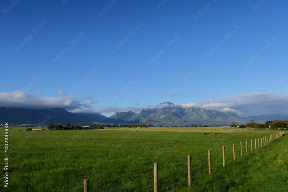 agricultural farmland in the foothills of a majestic mountain range