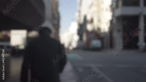 Wallpaper Mural Blur tracking shot of a man walking in the streets of Montevideo. Handheld Torontodigital.ca