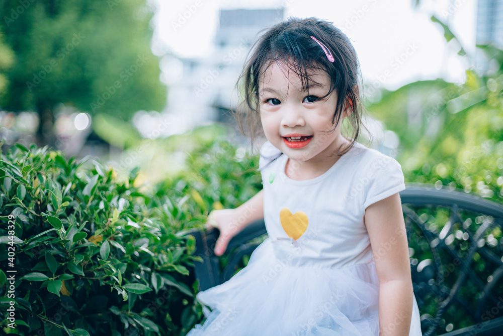 Sweet, happy, smiling three year old girl playing in a park outdoor. Sweet, happy, smiling three year old girl playing in a park outdoor.