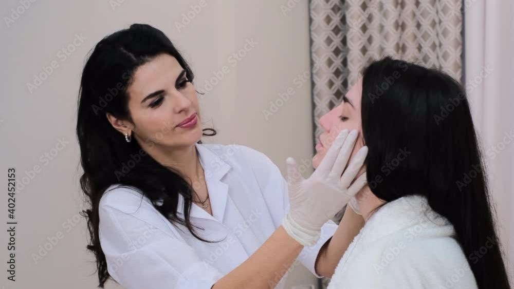 A client at a beautician's appointment, consultation, face shaping, preparation for upcoming procedures, visual examination of problem areas A client at a beautician's appointment, consultation, face shaping, preparation for upcoming procedures, visual examination of problem areas