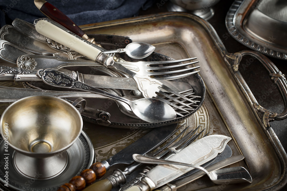 Silver dishes on old background Silver dishes on old background