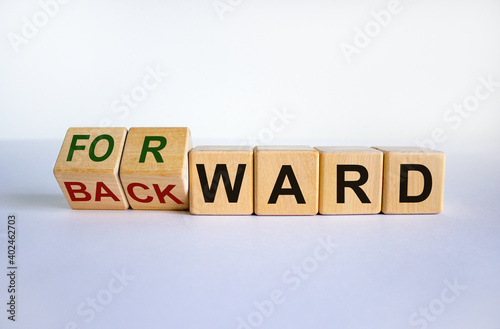 Forward or backward symbol. Turned cubes and changed the word 'backward' to 'forward' on wooden cubes. Beautiful white background, copy space. Business and forward or backward concept. photo