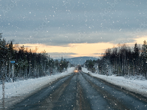 Evening winter snow road on the Kola peninsula. Traffic of cars. © sablinstanislav
