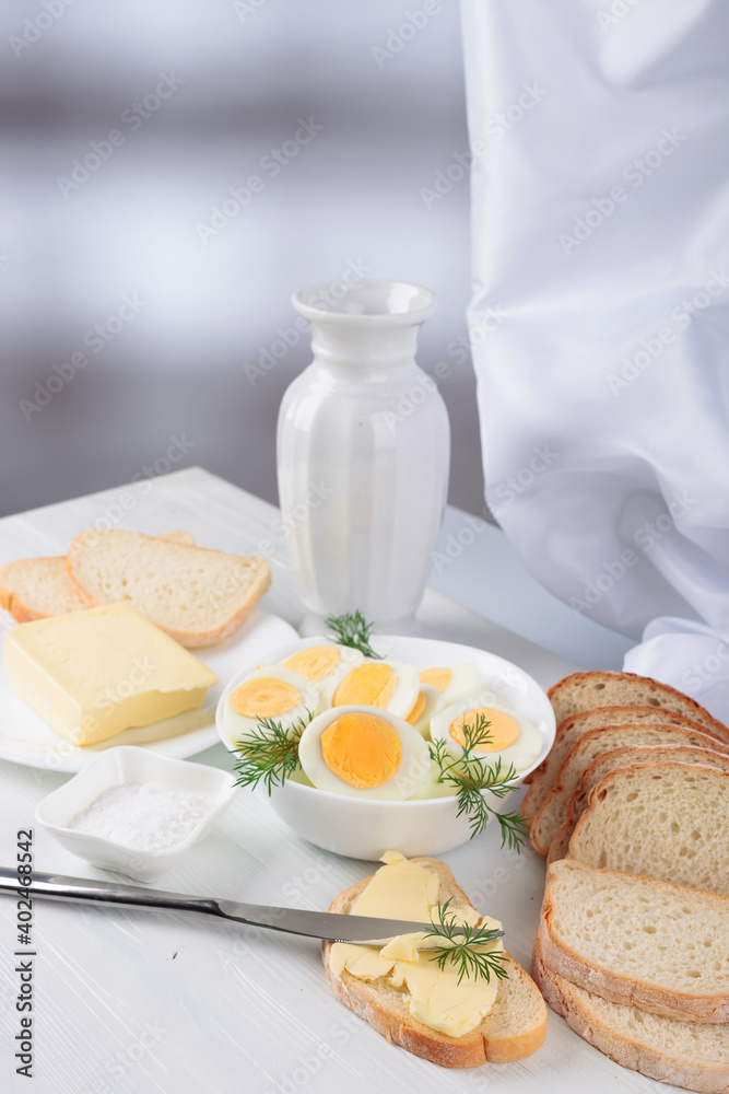 Boiled eggs with bread and salt.