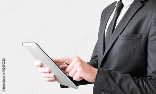 Businessman finger touching screen of a digital tablet at the departure gate of an airport