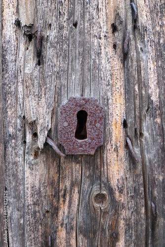 old wooden door and keyhole in sardinia, italy