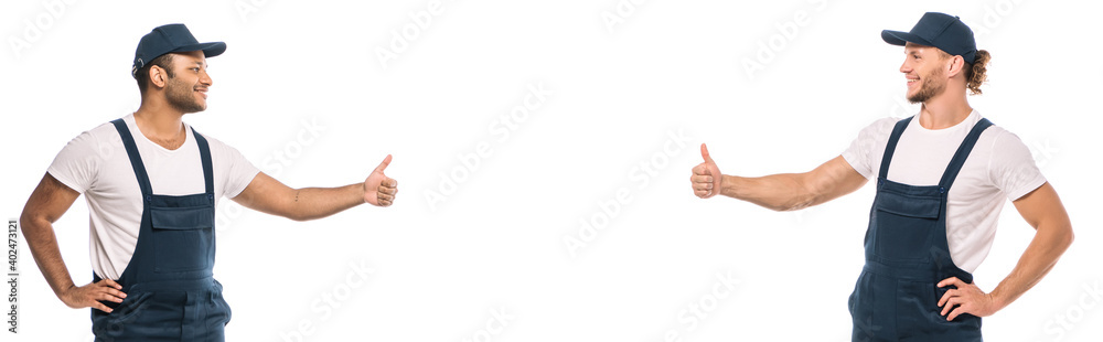 multicultural movers showing thumbs up and looking at each other isolated on white, banner multicultural movers showing thumbs up and looking at each other isolated on white, banner