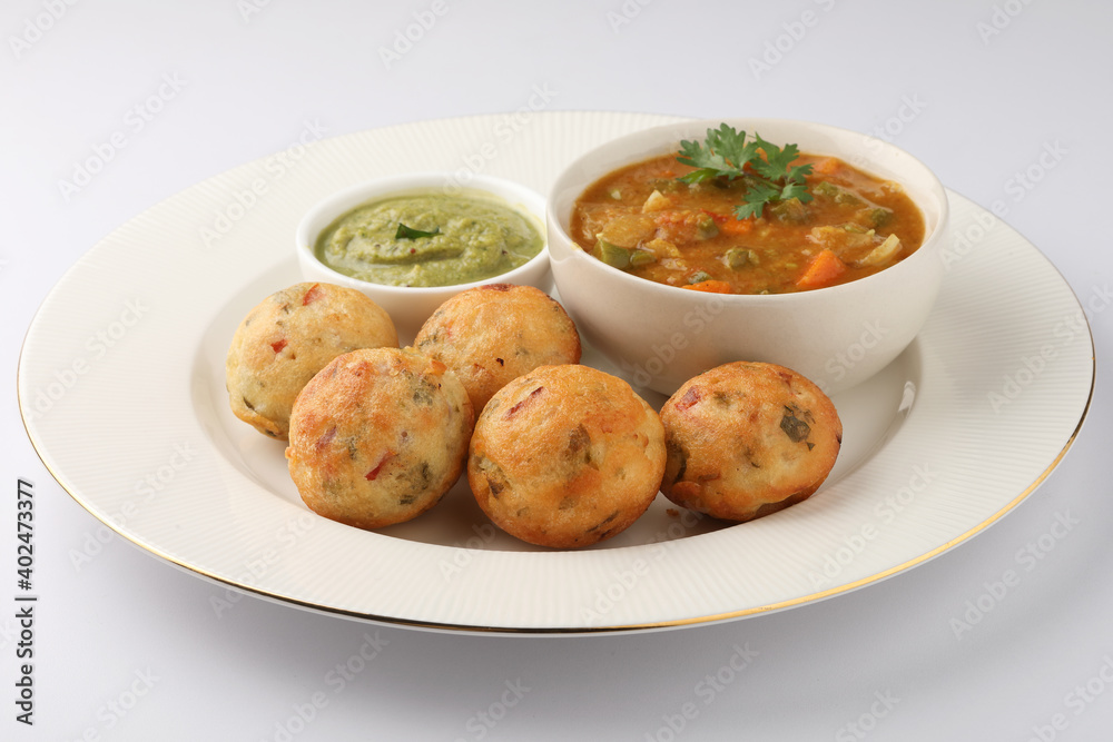 Kuzhi Paniyaram served with coconut chutney and sambar- South Indian breakfast Kuzhi Paniyaram served with coconut chutney and sambar- South Indian breakfast